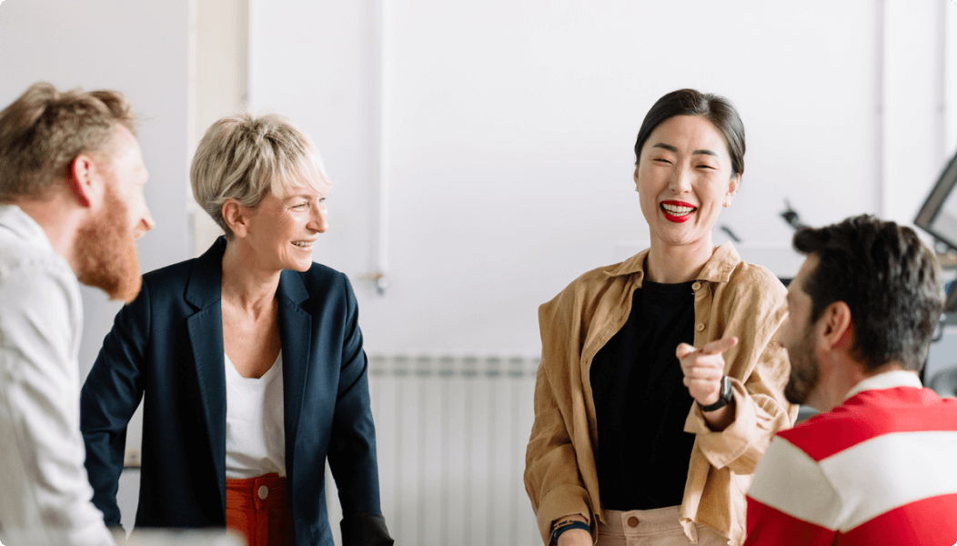 Image-of-four-colleagues-laughing-during-a-meeting